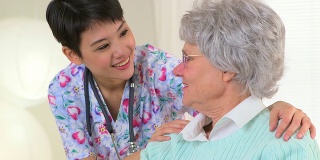 中国护士愉快地与老年病人交谈