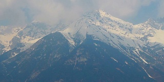 奥地利阿尔卑斯山雪山山峰上的云的时间流逝