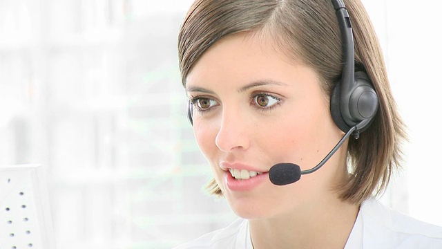 Smiling businesswoman with headset on