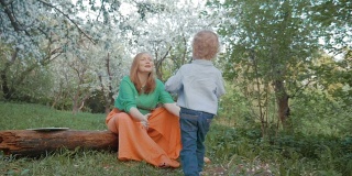 妈妈和小儿子在鲜花盛开的花园里度过了一段快乐的时光