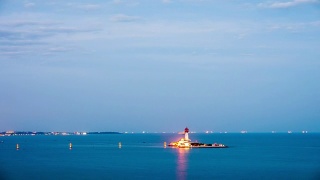 Beautiful sunset on coastline with powerful lighted lighthouse. Beidaihe, China.视频素材模板下载