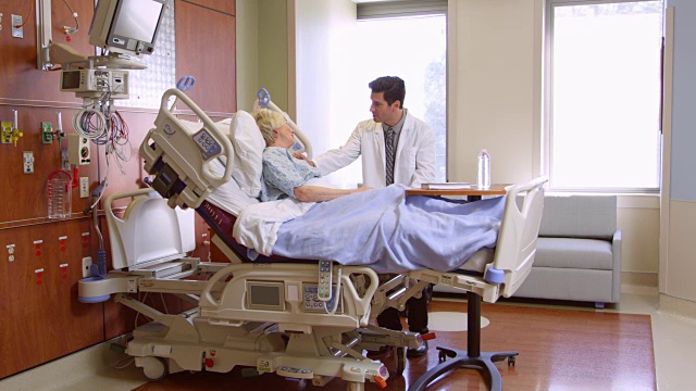 医生在医院病床上用R3D拍摄与老年病人谈话