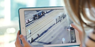 女人用触控板拍摄城市交通的照片