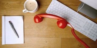 红色的电话听筒掉到办公桌上