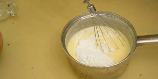 将面粉与搅打好的鸡蛋和糖混合，制作蛋海绵