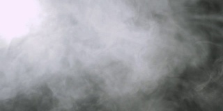 烟的背景。抽象的烟雾云。黑色背景上慢动作的烟雾
