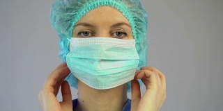 医生为手术做准备，检查病人，外科医生戴上口罩