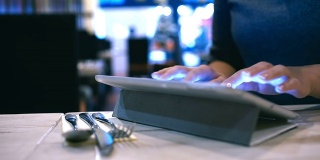 一个女人在咖啡馆的便签本上输入信息或电子邮件
