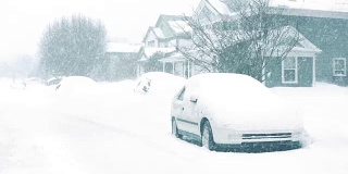 暴风雪中的房屋和汽车