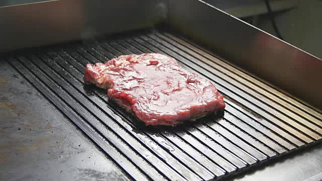 在烤架上烤美味多汁的肉排