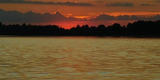 彩色日落的河与太阳和橙色的云