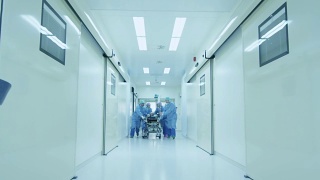 医院急救小组抬着病人担架穿过医院大厅视频素材模板下载