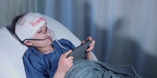 医院拍摄的4k受伤儿童戴着氧气面罩在平板电脑上玩游戏