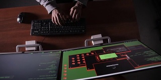 前视图。一个男人在暗室里用手敲打键盘。黑客，it专家，电脑专家。认不出来