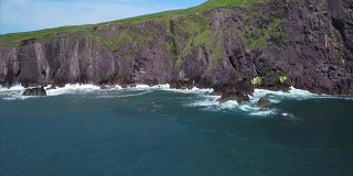 海面的航拍镜头由多岩石的小山悬崖面对