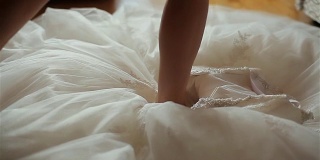 从下往上穿晚礼服。优雅的蕾丝婚纱地板新娘的腿进入。女舞者穿上芭蕾舞短裙。准备穿豪华正式的宴会礼服。魅力女孩的生活方式