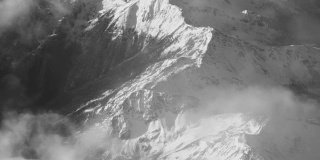 Vintage Black And White Aerial View of Clouds And Snow Covered Alps Mountains