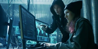 国际通缉的男孩和女孩黑客组织对公司服务器的高级病毒攻击。地方是黑暗的，有多个显示器。