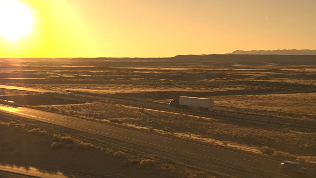空运货物的卡车、汽车在美国辽阔的平原上公路行驶