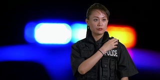 亚裔美国女警察在犯罪现场使用无线电