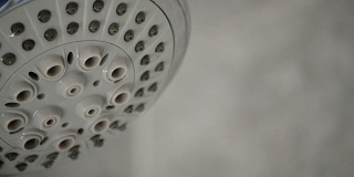 淋浴龙头开着喷出浴缸中的水的细节