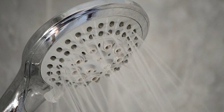 淋浴龙头打开，在浴缸中喷出水
