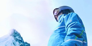 低角度的女性滑雪者把她的眼镜在蓝色的天空