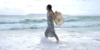 带着围巾在海上漫步的年轻女子