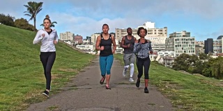 四个人在旧金山的一个公园里跑步