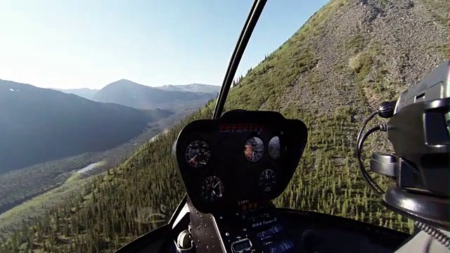 Helicopter flying over a mountain slope
