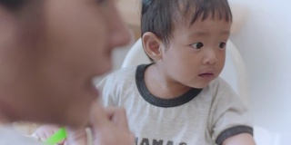 亚洲男婴(6-11个月)在家吃婴儿食品