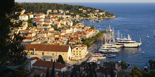 Amazing sunset over Hvar city and bay with yachts, Hvar island, Croatia