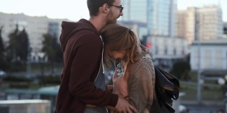 一对年轻英俊的夫妇站在市中心拥抱。快乐的男女正在进行浪漫的约会
