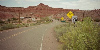 在蜿蜒的沙漠公路上驾驶汽车