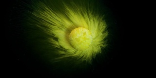 黄色药丸溶解在水中，看起来就像一个行星抽象的背景