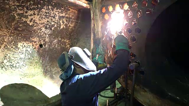 Welder at work in boiler industry.