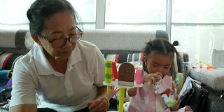 亚洲婴儿玩贸易冰淇淋与祖母