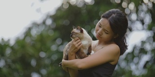 一位年轻女子在抚摸一只猫