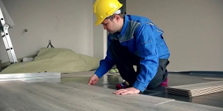 熟练的建筑大师铺设木地板