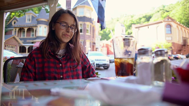 这位美丽的16岁少女在宾夕法尼亚州波科诺斯地区吉姆·索普的街头咖啡馆里喝可乐