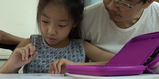 亚裔父亲和女儿在家画画