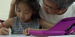 亚裔父亲和女儿在家画画