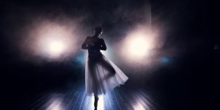 一个芭蕾舞演员以舞蹈的动作走向镜头。