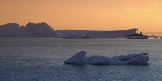 北冰洋上的冰山和格陵兰岛的日落