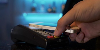 顾客在餐厅酒吧使用智能手机支付，使用pos和非接触式无线技术