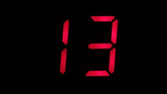 Digital clock countdown from sixteen to zero. Digital timer in red color over black background