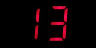 Digital clock countdown from sixteen to zero. Digital timer in red color over black background