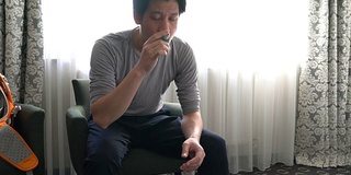 在家中使用哮喘吸入器预防慢性疾病的男子