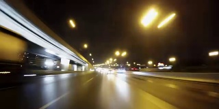 Night road POV through the city at night timelapse. View of the cars behind. Loopable