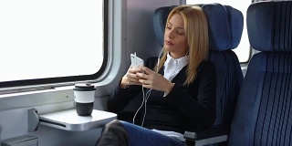 女商人在火车上听音乐